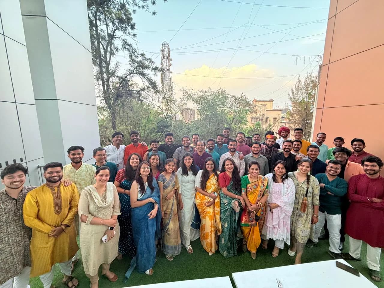 Nirmitee team gathered outdoors in colourful traditional clothing