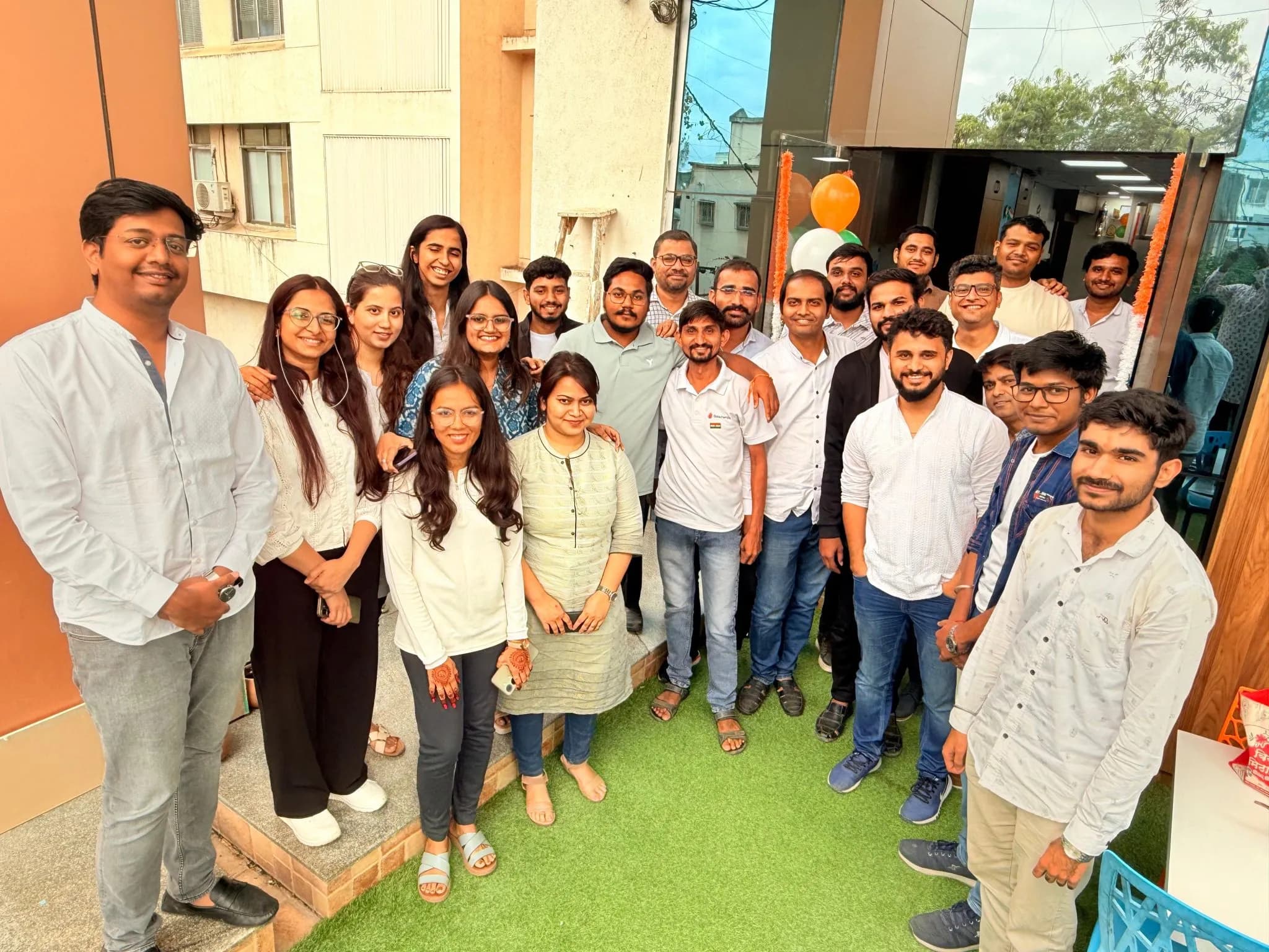 Nirmitee colleagues gathered outside the office with festive decorations