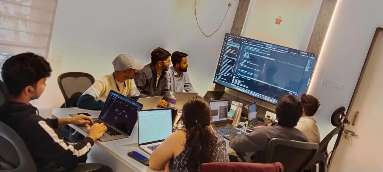 Nirmitee colleagues reviewing code together around a shared screen